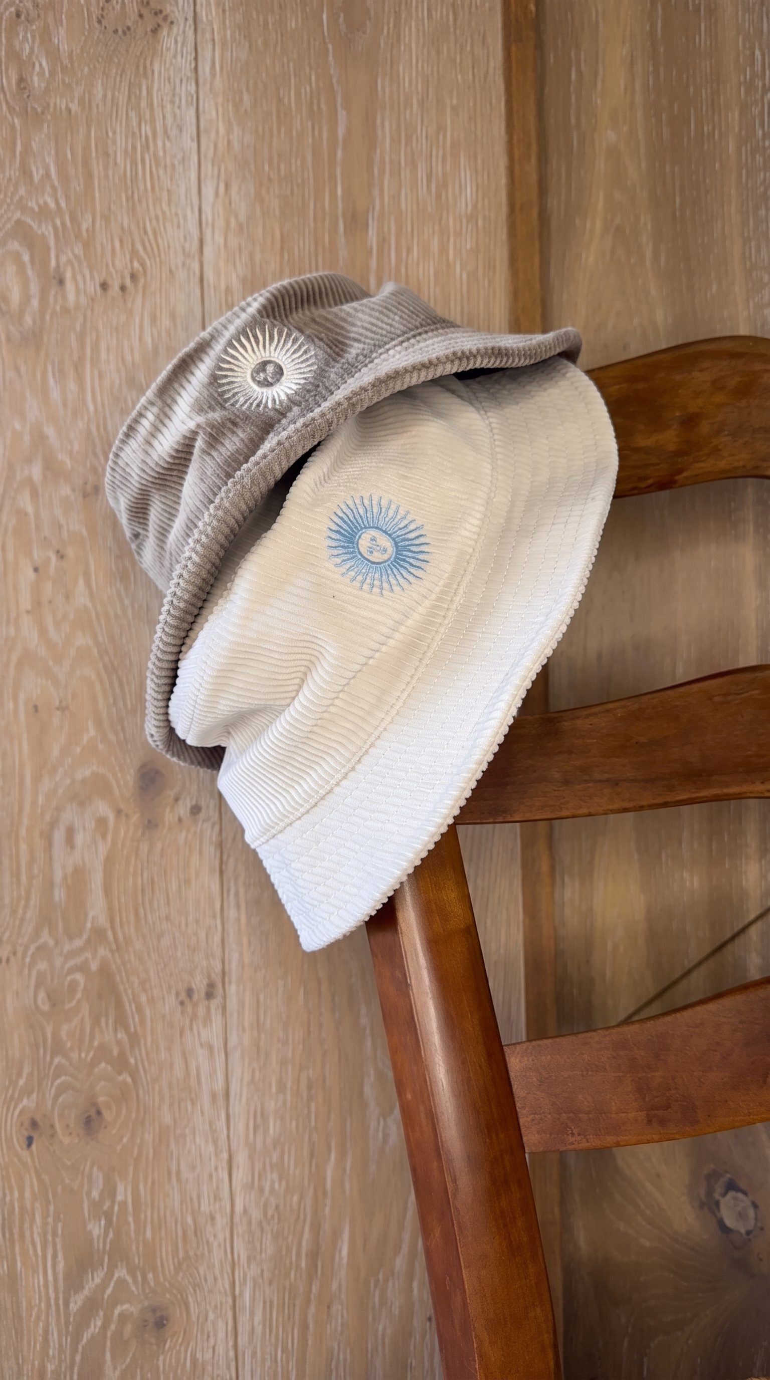 The cacao and crema pilusos together on a rush-seat chair.